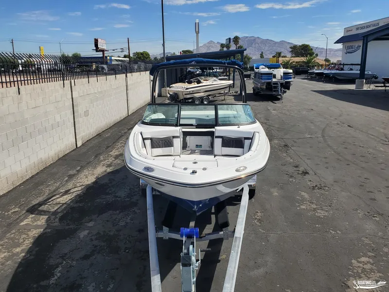 Slide: The Image of 2023 Monterey M22 boat on trailer at dealership, mountain backdrop. - 17