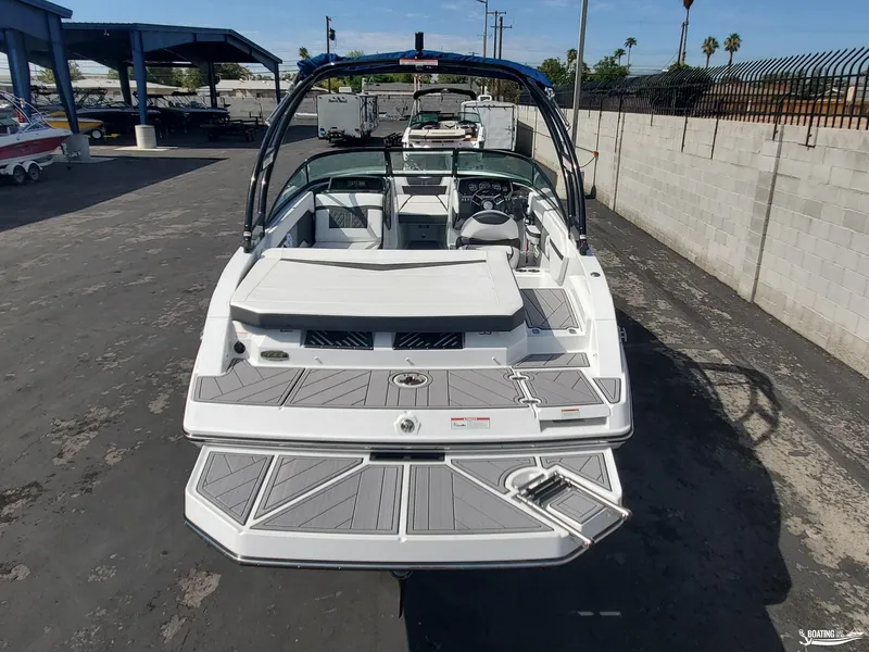 Slide: The Image of 2023 Monterey M22 boat, rear view, parked on asphalt, showcasing sleek design and spacious interior. - 20