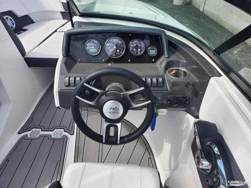 Slide: The Image of 2023 Monterey M22 boat dashboard with steering wheel and control panel. - 5