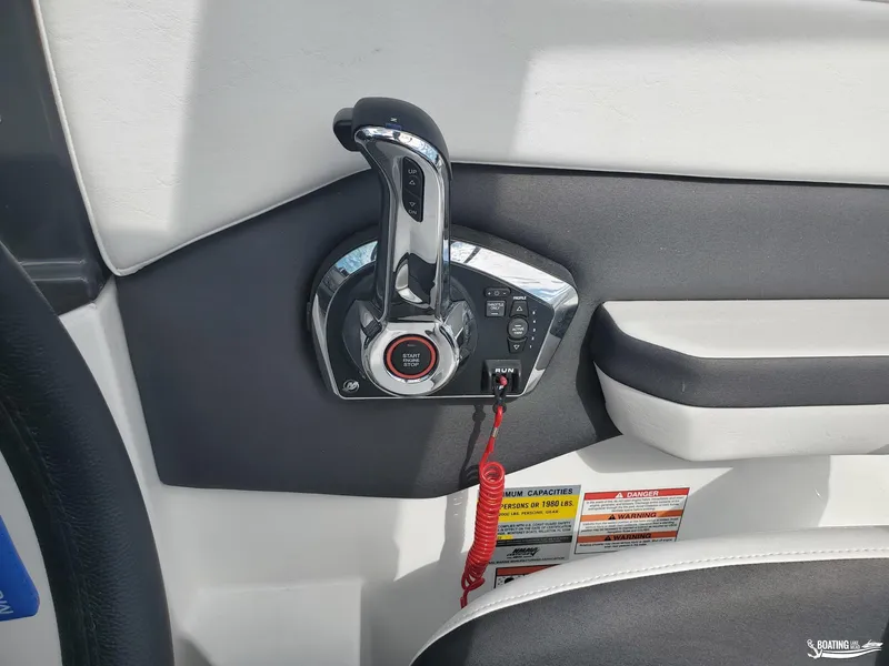 Slide: The Image of 2023 Monterey M22 boat throttle control with start/stop button and safety warnings. - 6