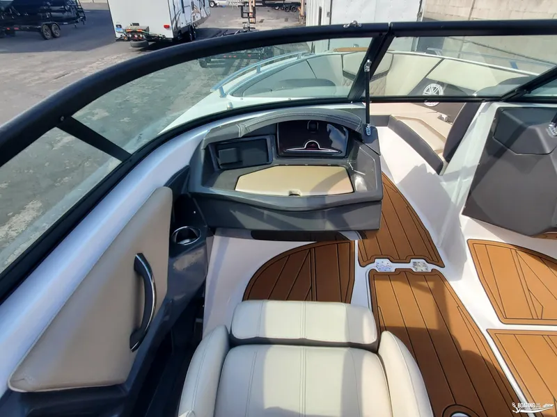 Slide: The Image of 2023 Monterey 238SS boat interior with modern dashboard and wood-style flooring. - 11