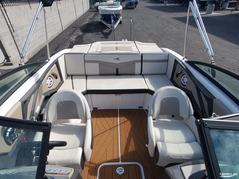 Slide: The Image of 2023 Monterey 238SS boat interior with white seating and wood-style flooring. - 15
