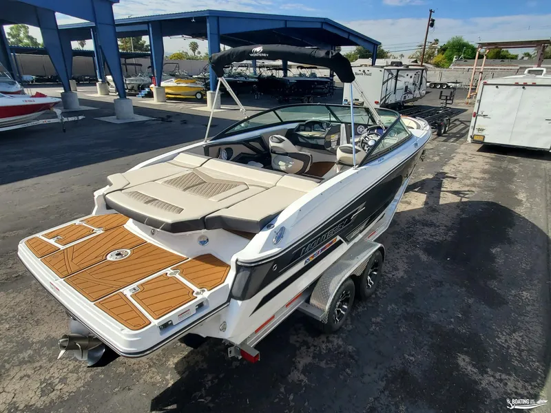 Slide: The Image of 2023 Monterey 238SS boat on trailer, featuring sleek design and spacious seating. - 5