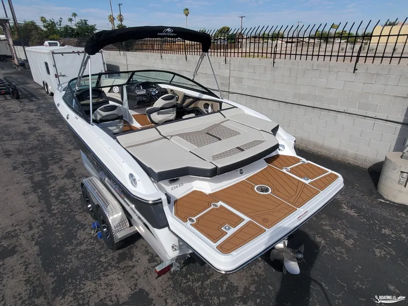 Slide: The Image of 2023 Monterey 238SS boat with sleek design and spacious seating, parked on a trailer. - 8
