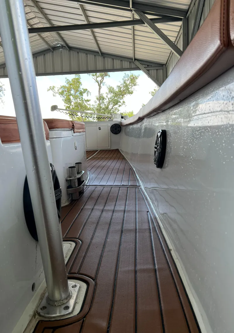 Slide: The Image of 1986 Custom 38 Coyote boat interior with brown deck and white sides. - 10