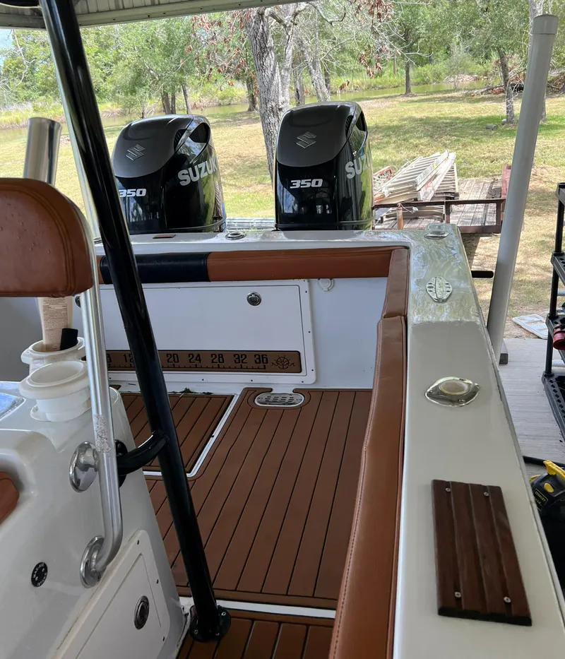 Slide: The Image of Custom 1986 38 Coyote boat with twin Suzuki 350 engines, docked outdoors. - 13