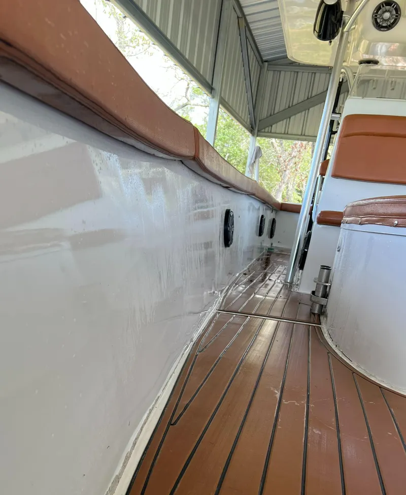 Slide: The Image of 1986 Custom 38 Coyote boat interior with brown seating and wooden flooring. - 8