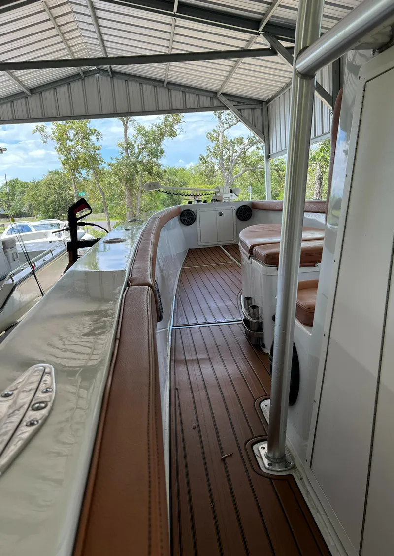 Slide: The Image of 1986 Custom 38 Coyote boat interior with brown seating and wood flooring. - 9