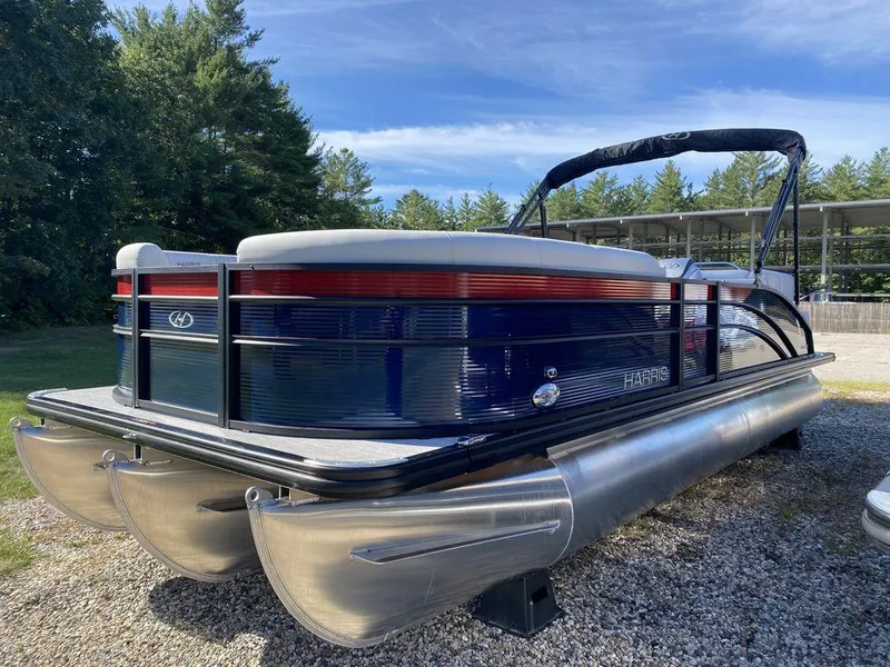 Slide: The Image of 2023 Harris Cruiser 230 CWDH pontoon boat on gravel lot with trees in background. - 1