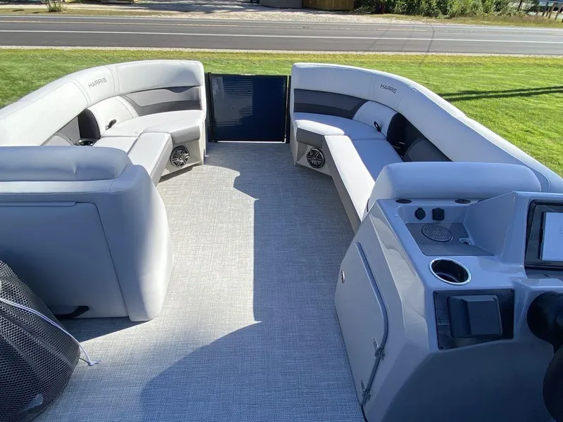 Slide: The Image of 2023 Harris Cruiser 230 CWDH pontoon boat interior with spacious seating and modern console. - 6