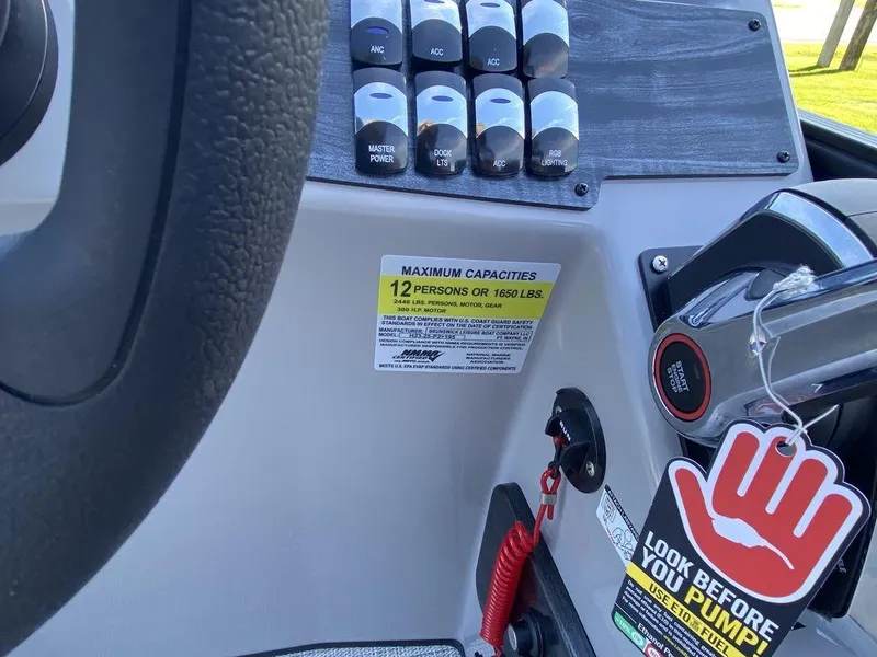 Slide: The Image of Control panel of 2023 Harris Cruiser 230 CWDH boat with capacity label. - 9