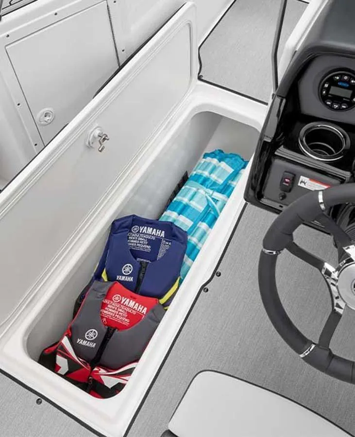 Slide: The Image of 2023 Yamaha Boats AR195 storage compartment with life jackets and inflatables. - 5