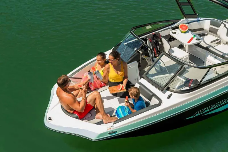 Slide: The Image of Family enjoying a day on a 2023 Yamaha Boats AR195 in the water. - 8