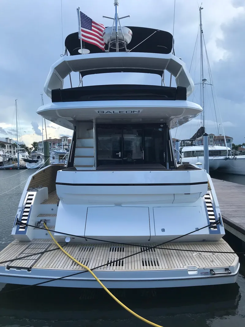 Slide: The Image of 2022 Galeon 470 Skydeck yacht docked at marina, rear view. - 3