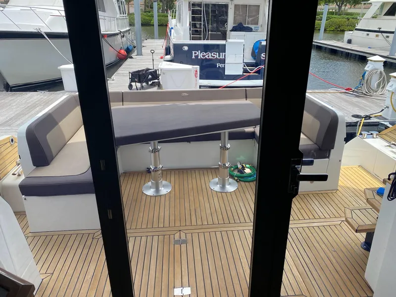 Slide: The Image of 2022 Galeon 470 Skydeck yacht with spacious outdoor seating area at the dock. - 7