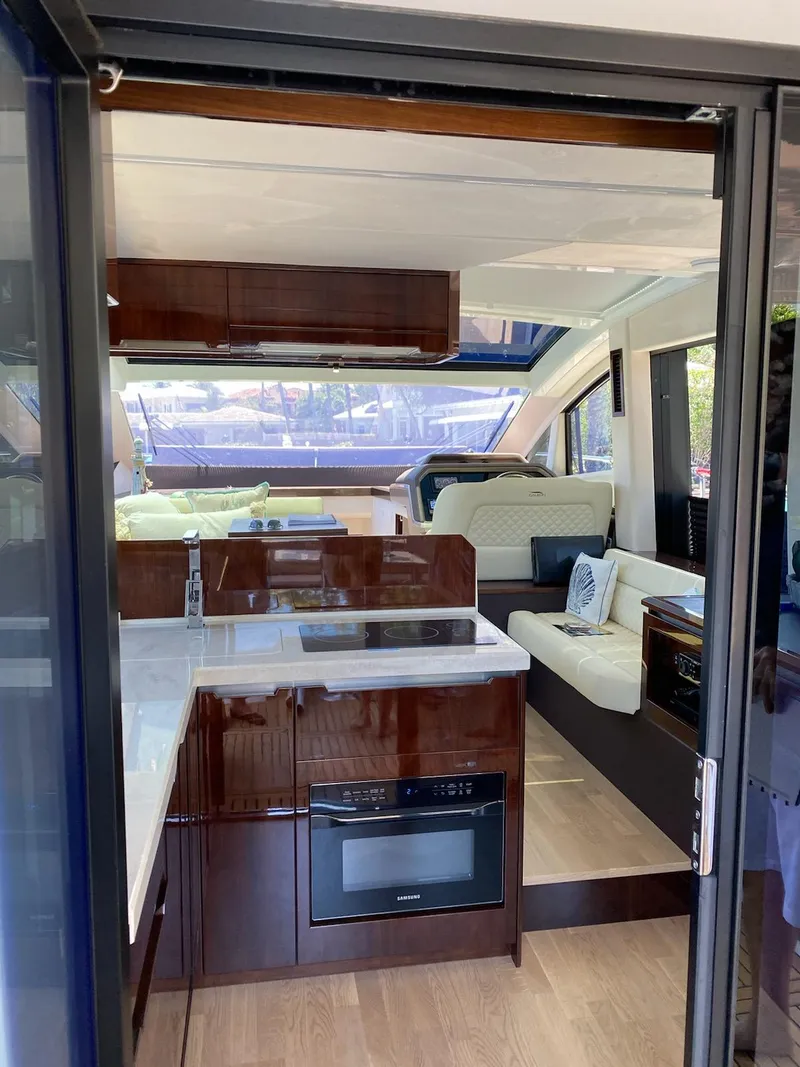 Slide: The Image of Interior of 2022 Galeon 470 Skydeck yacht with modern kitchen and seating area. - 8
