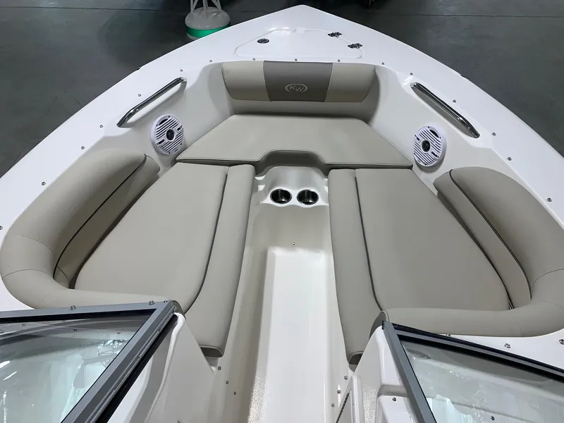 Slide: The Image of 2024 Key West 203 DFS boat interior with cushioned seating and cup holders. - 12