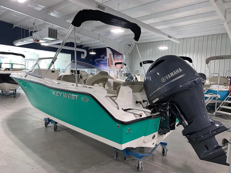 Slide: The Image of 2024 Key West 203 DFS boat with Yamaha outboard motor in showroom. - 2