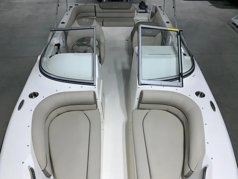 Slide: The Image of 2024 Key West 203 DFS boat interior with beige seating and open windshield. - 3