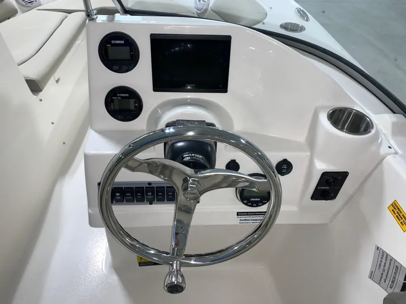 Slide: The Image of 2024 Key West 203 DFS boat dashboard with steering wheel, gauges, and control panel. - 8