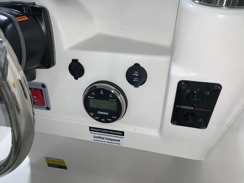 Slide: The Image of 2024 Key West 203 DFS boat dashboard with Clarion audio system and Yamaha controls. - 9