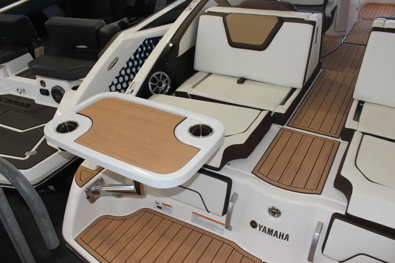 Slide: The Image of 2023 Yamaha Boats 252SE interior with seating and table. - 13