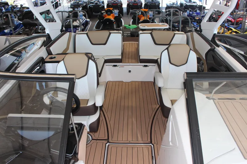 Slide: The Image of 2023 Yamaha Boats 252SE interior with luxurious seating and teak flooring. - 5