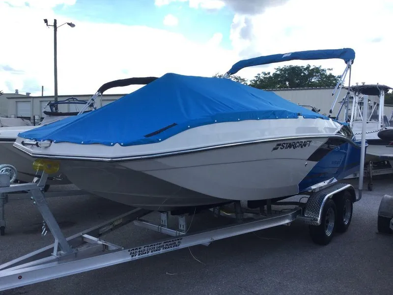 Slide: The Image of 2023 Starcraft SVX 191 boat on trailer with blue cover. - 4