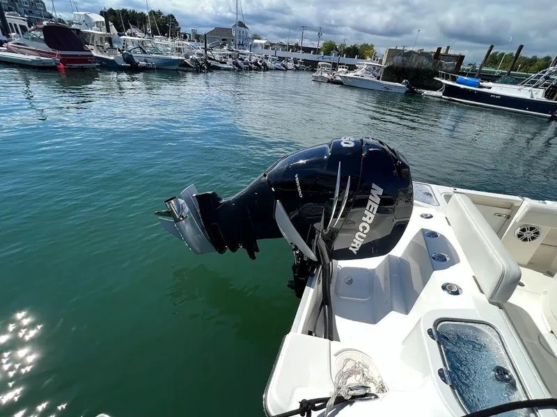Slide: The Image of 2020 Mako 236 CC boat with Mercury outboard motor docked in marina. - 3