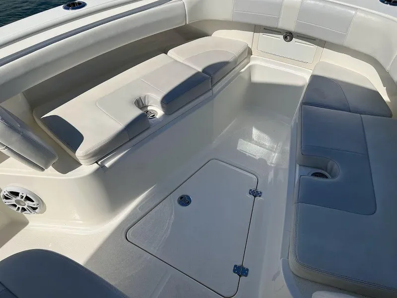 Slide: The Image of 2020 Mako 236 CC boat interior with cushioned seating and storage compartments. - 4