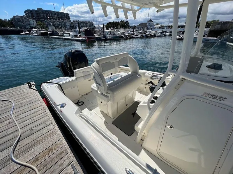 Slide: The Image of 2020 Mako 236 CC boat docked in a marina, showcasing seating and console. - 6