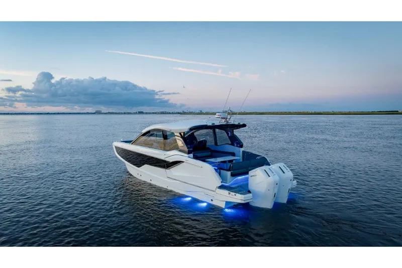 Slide: The Image of 2023 Galeon 375 GTO luxury yacht on calm waters at sunset. - 3
