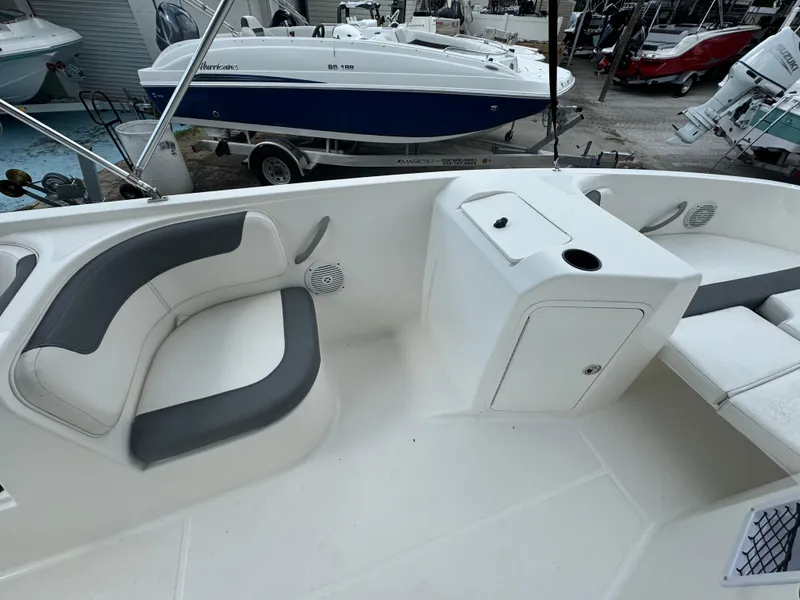 Slide: The Image of 2023 Bayliner E21 boat interior with seating and storage compartments. - 5