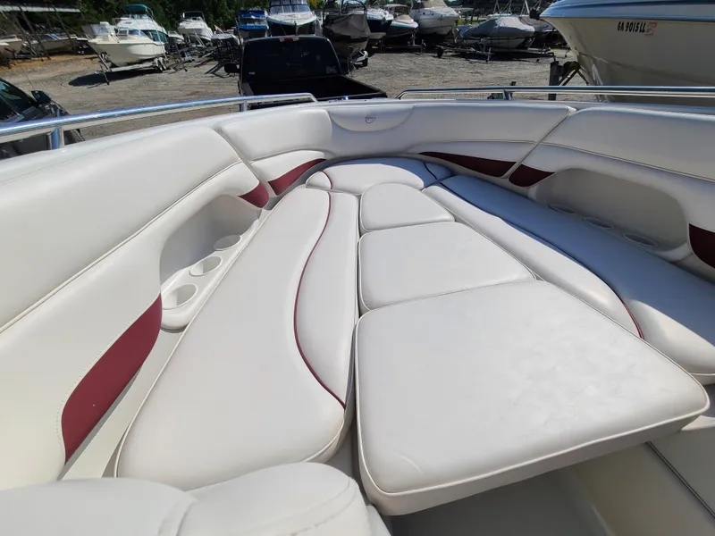 Slide: The Image of 2003 Crownline 230BR boat interior with white and red cushioned seating. - 10