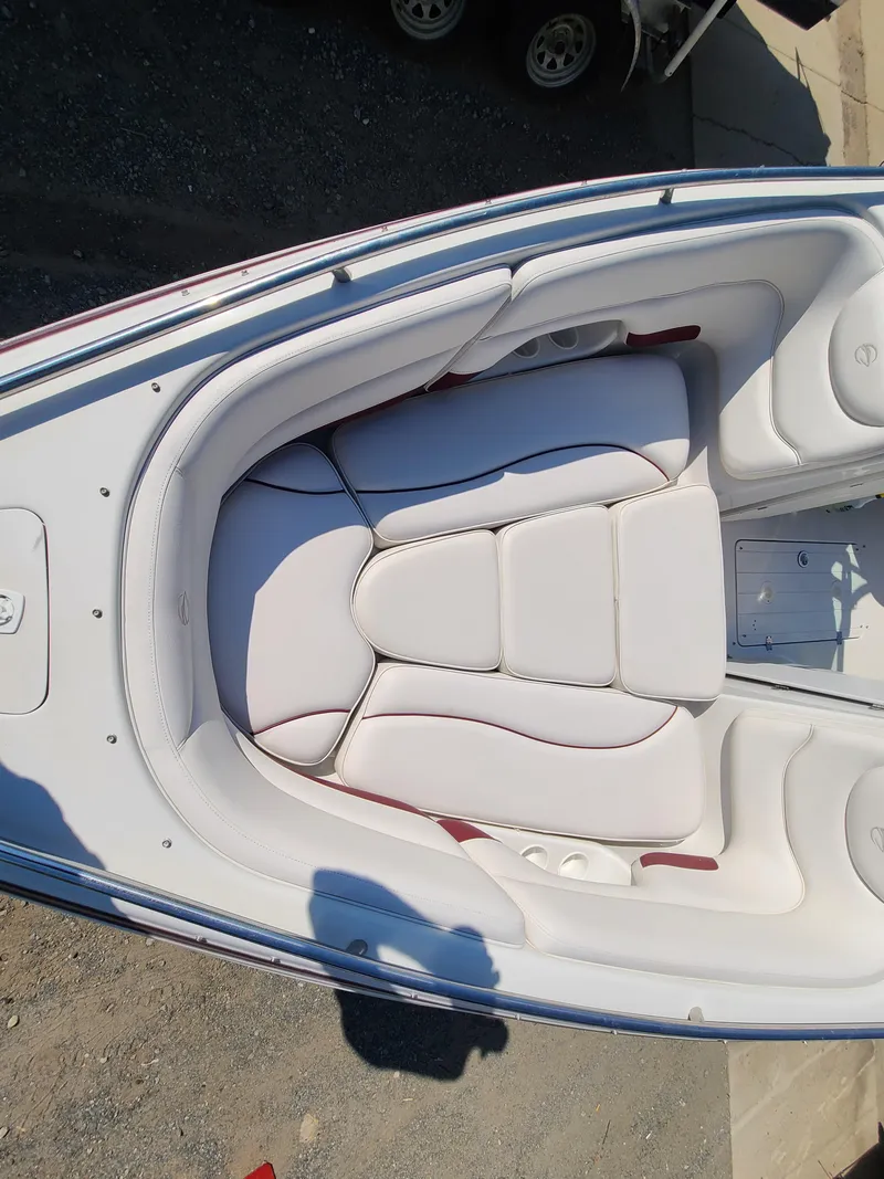 Slide: The Image of 2003 Crownline 230BR boat with white cushioned seating. - 11
