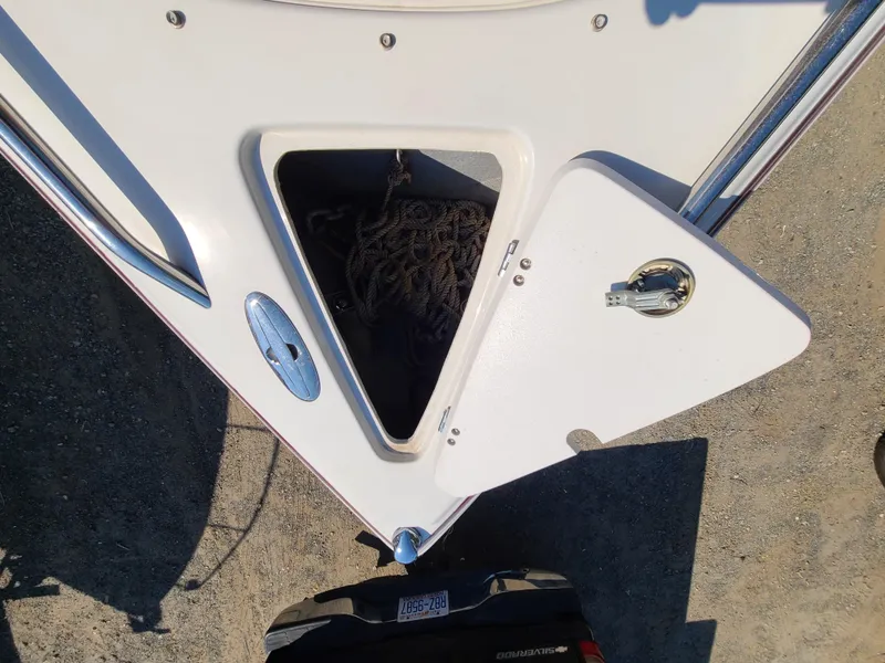 Slide: The Image of Open storage compartment on a 2003 Crownline 230BR boat. - 12
