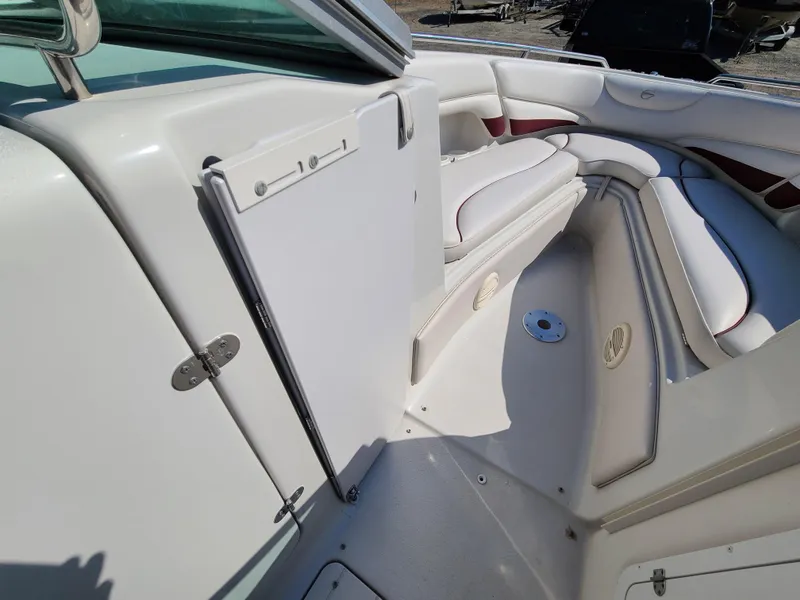 Slide: The Image of 2003 Crownline 230BR boat interior with white and red seating. - 13