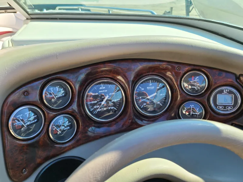 Slide: The Image of Dashboard of a 2003 Crownline 230BR boat with multiple gauges. - 16