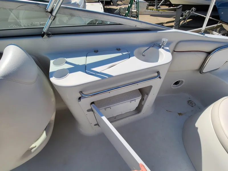 Slide: The Image of 2003 Crownline 230BR boat interior with sink and storage compartment. - 22