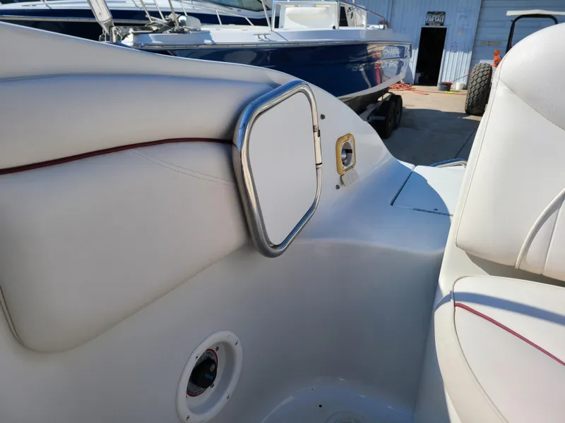 Slide: The Image of 2003 Crownline 230BR boat interior with white and red upholstery. - 25
