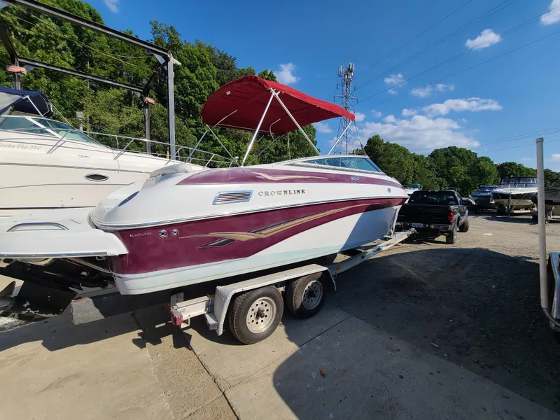 Slide: The Image of 2003 Crownline 230BR boat with red canopy on trailer. - 3
