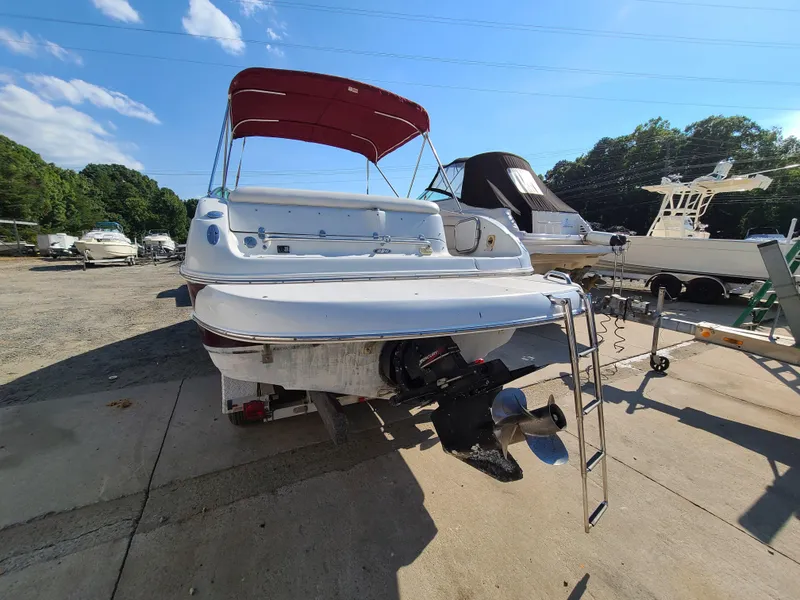 Slide: The Image of 2003 Crownline 230BR boat with red canopy, docked at a marina. - 5