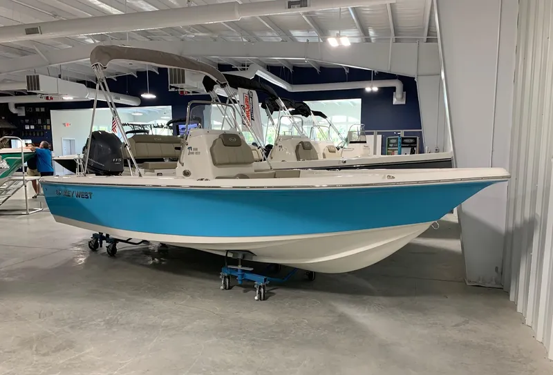 Slide: The Image of 2024 Key West 188 Bay Reef boat in showroom, blue and white hull. - 0