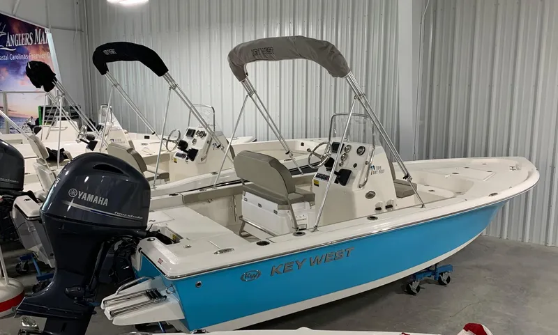 Slide: The Image of 2024 Key West 188 Bay Reef boat with Yamaha outboard motor in showroom. - 1