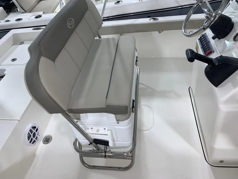 Slide: The Image of 2024 Key West 188 Bay Reef boat interior with cushioned seating and steering console. - 9