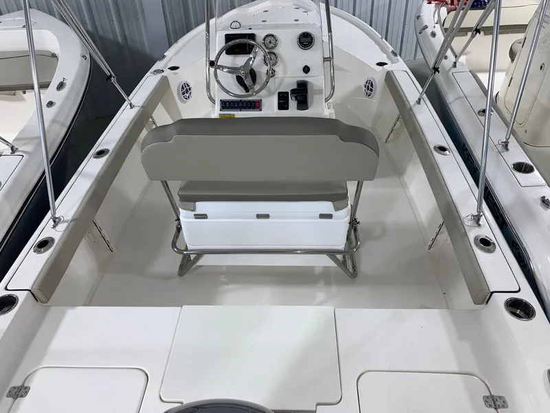 Slide: The Image of 2024 Key West 188 Bay Reef boat interior with steering console and seating. - 2