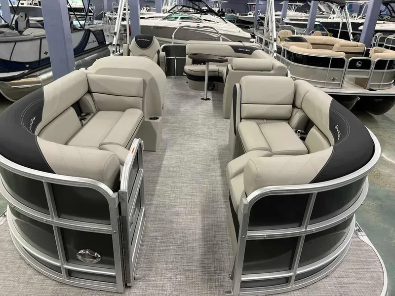 Slide: The Image of 2023 South Bay 222 CR LE 2.75 pontoon boat with spacious seating in a showroom. - 2