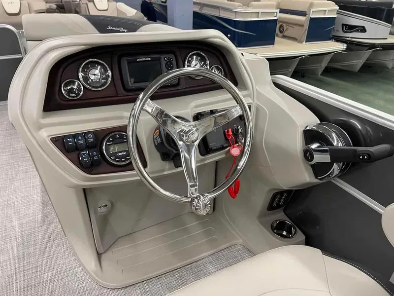 Slide: The Image of 2023 South Bay 222 CR LE 2.75 boat dashboard with steering wheel and control panel. - 7
