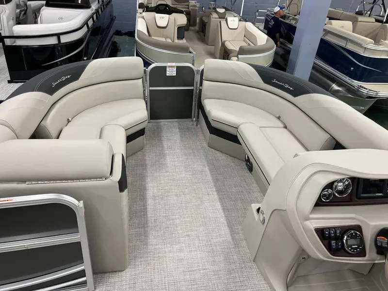Slide: The Image of 2023 South Bay 222 CR LE 2.75 pontoon boat interior with beige seating and modern dashboard. - 8