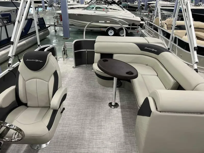 Slide: The Image of 2023 South Bay 222 CR LE 2.75 pontoon boat interior with plush seating and captain's chair. - 9